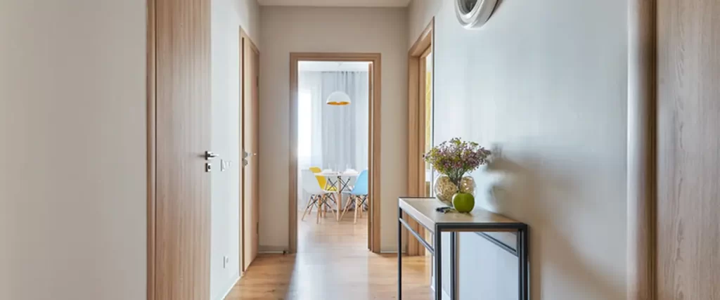 modern hallway with wooden flooring minimalist console table and wall clock