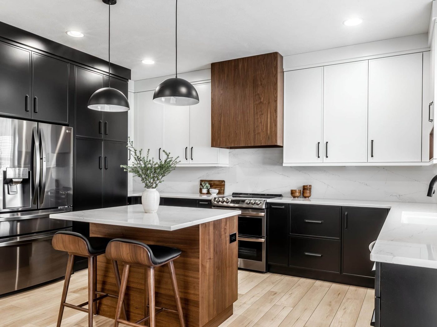 A close-up of refinished black kitchen cabinets in Wichita, KS, with sleek matte black finish and a polished granite countertop. The modern design features minimalist black hardware and premium materials, emphasizing expert cabinet refinishing.